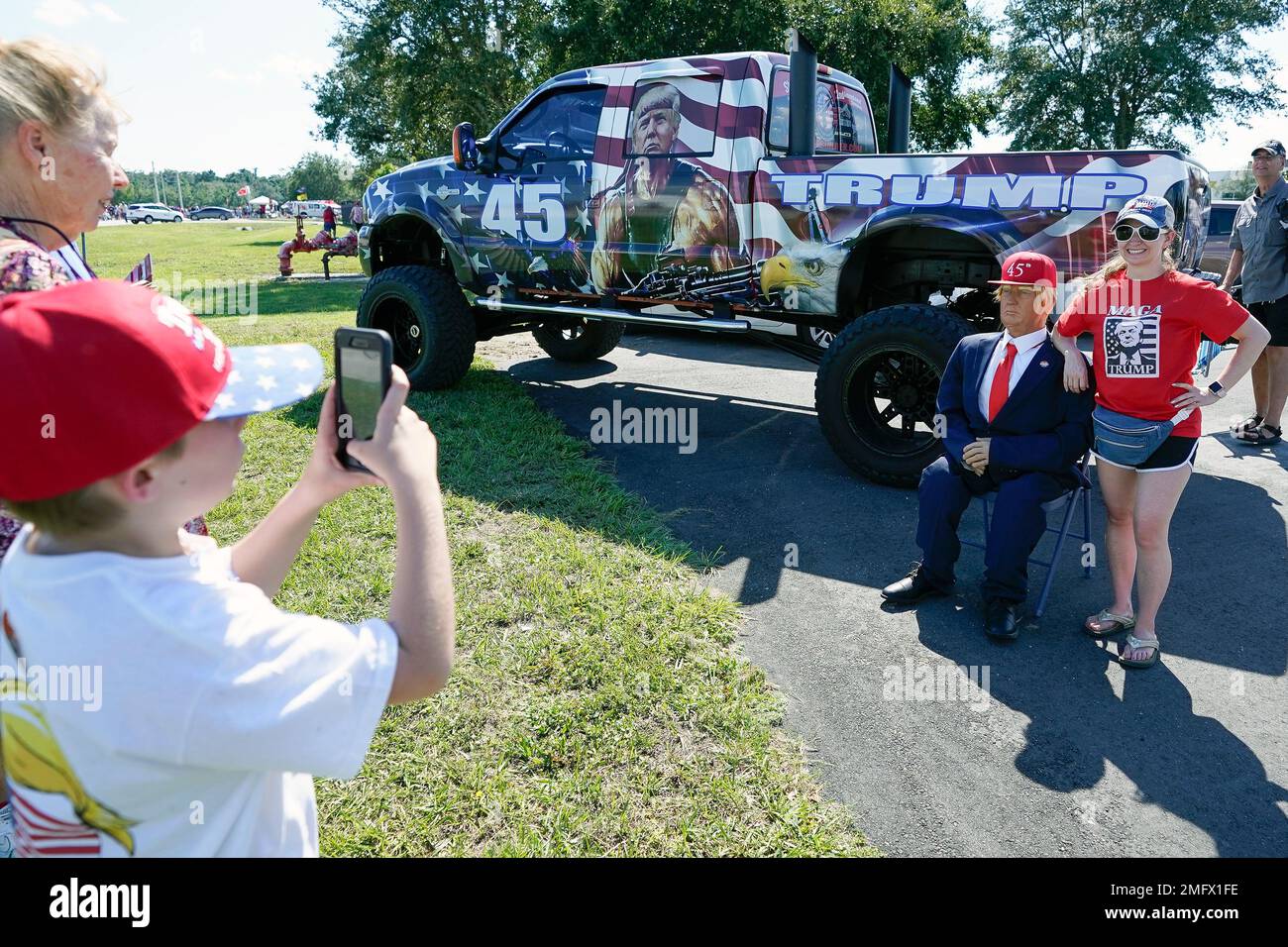 Supporters of President Donald Trump pose for a photo next to a