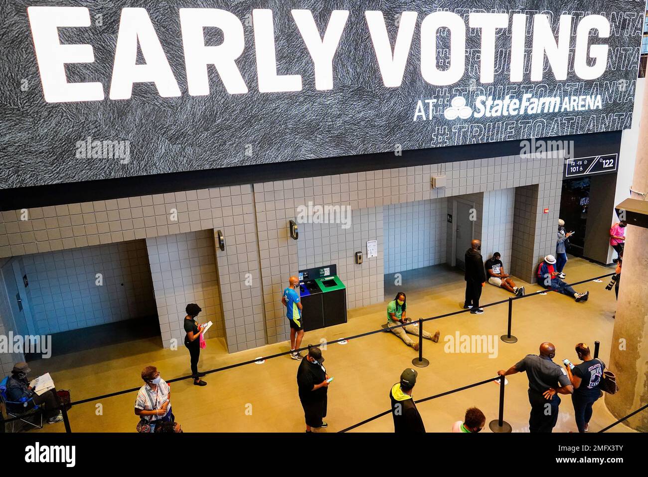People wait in line to vote early at the State Farm Arena on Monday, Oct. 12, 2020, in Atlanta. (AP Photo/Brynn Anderson) Stock Photo