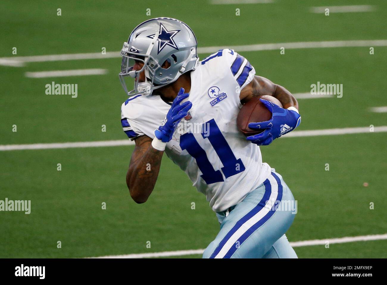 Dallas Cowboys wide receiver Cedrick Wilson (11) gains first down yardage  after catching a pass in the first half of an NFL football game against the  New York Giants in Arlington, Texas,