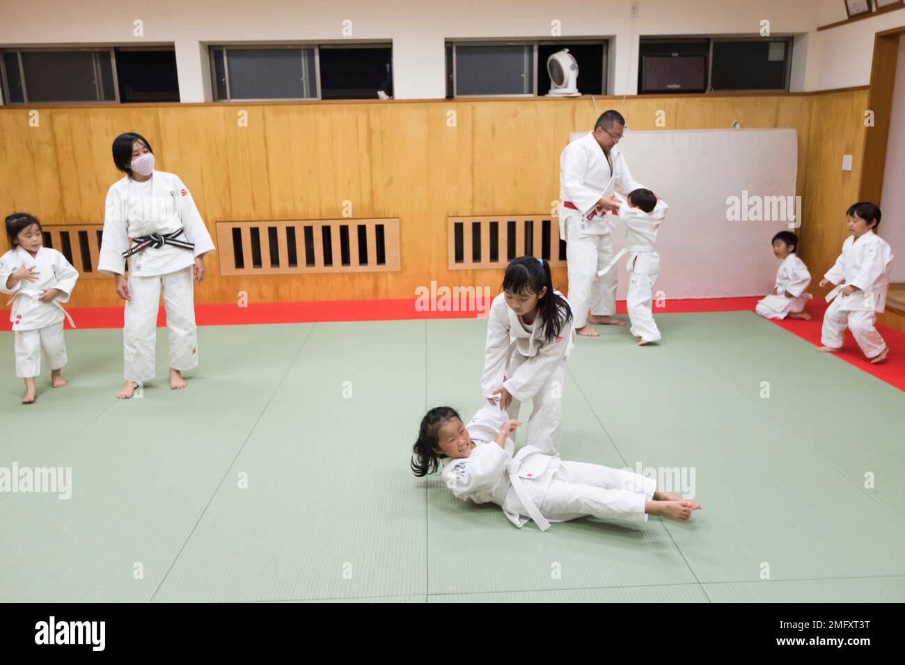 Judo teacher Miyoko Hamana, second left, watches her elementary school