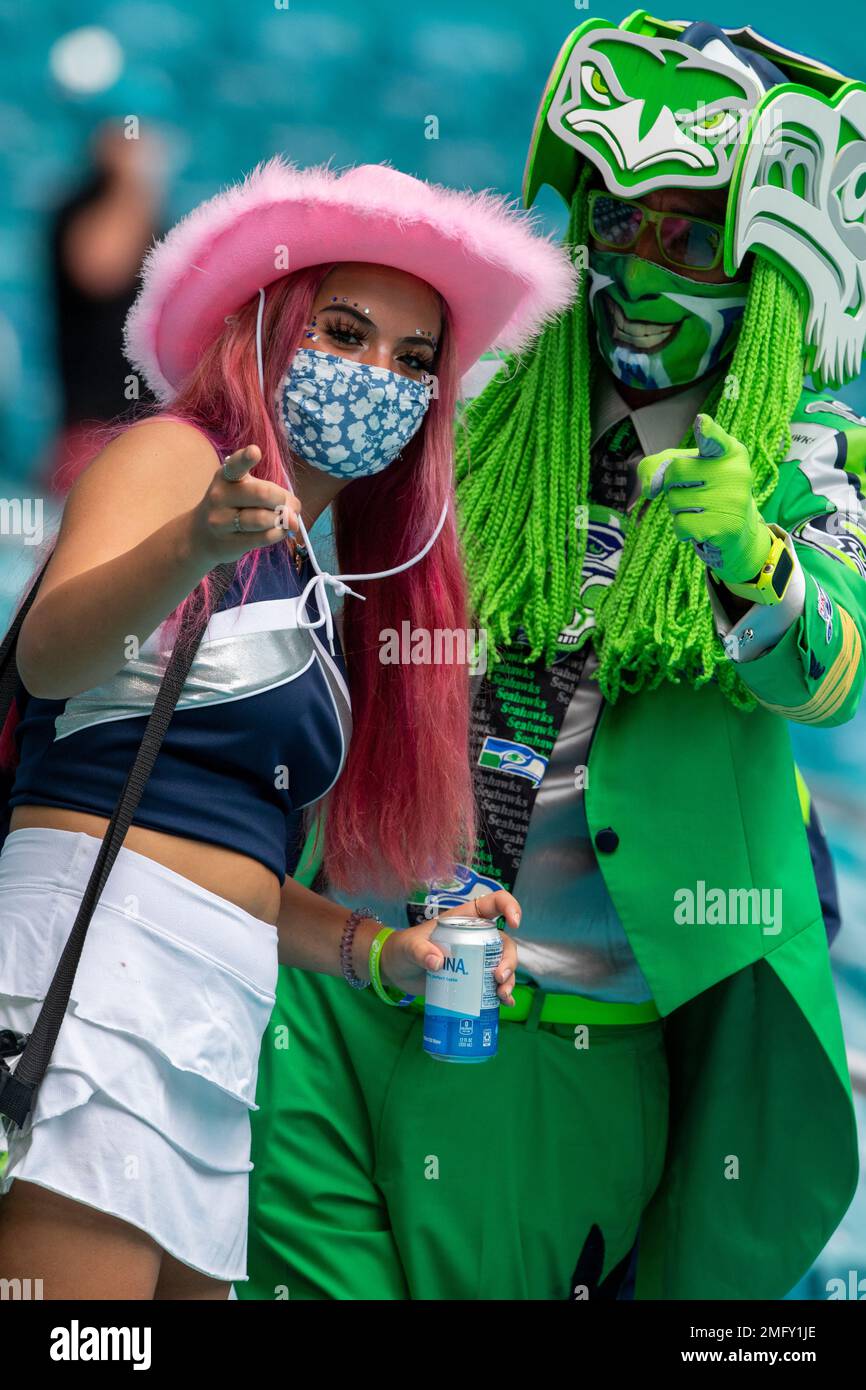 Seattle Seahawk fans wearing costumes and face masks in the stands ...