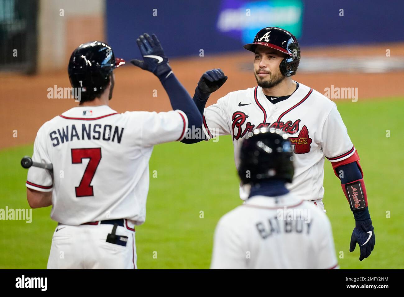 Atlanta Braves' Dansby Swanson (7) celebrates with bench coach