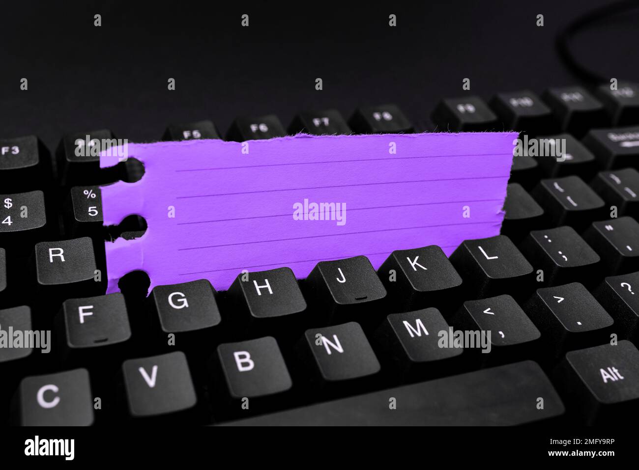 Colored sticker lying on keyboard. Important message written over paper. Stock Photo