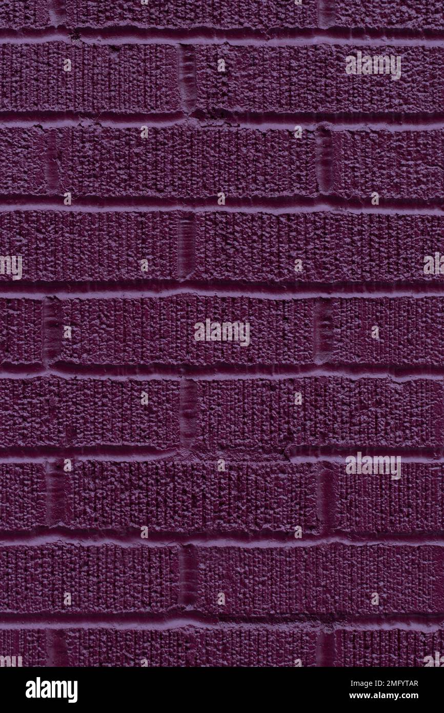 Painted purple brick wall texture vertical background Stock Photo