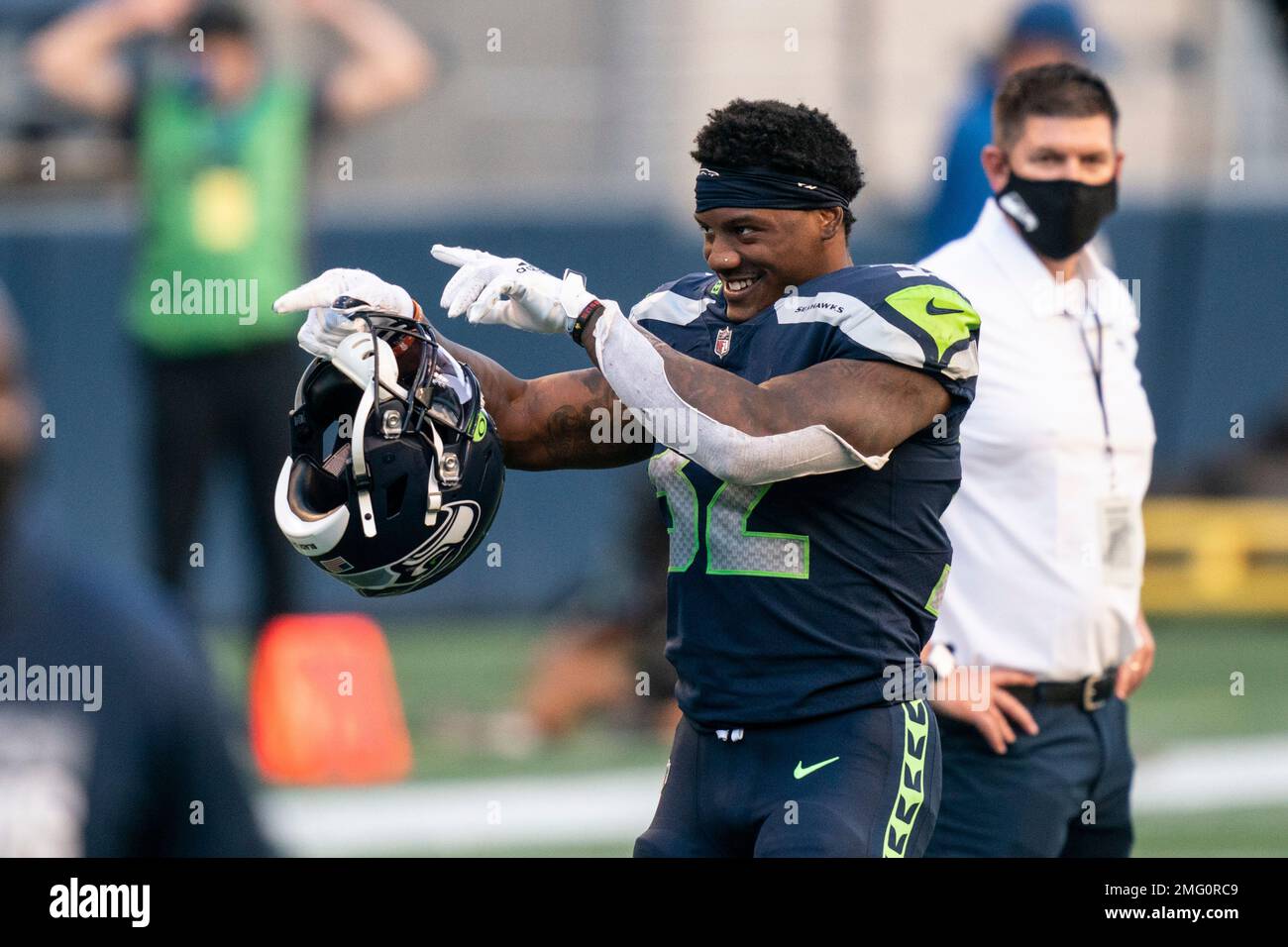 Seattle Seahawks running back Chris Carson gestures while smiling