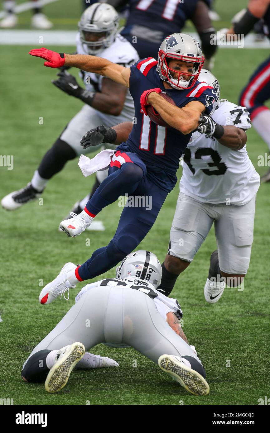 Raiders defensive end Maxx Crosby (98) stretches before an NFL