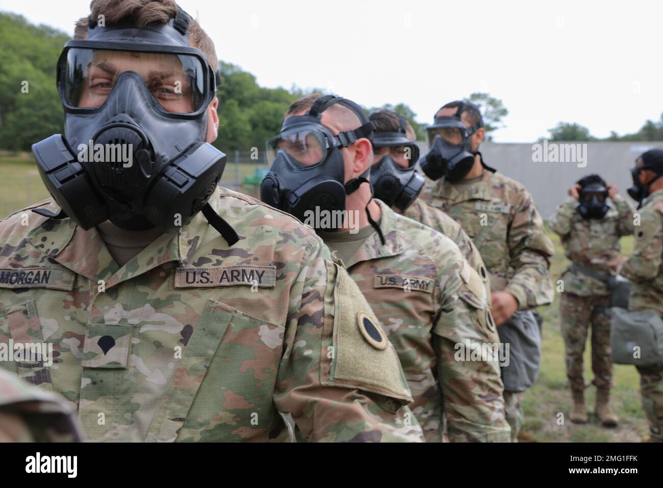U.S. Army Spc. Joshua Morgan, an intelligence analyst assigned to the 37th Infantry Brigade Combat Team, prepares for a Chemical, Biological, Radioactive and Nuclear (CBRN) training exercise to begin at Camp Grayling, Michigan, Aug. 20, 2022. The CBRN training required the Soldiers to be exposed to a mild and benign chemical irritant in order to build confidence in using their M50 Gas Mask. Stock Photo