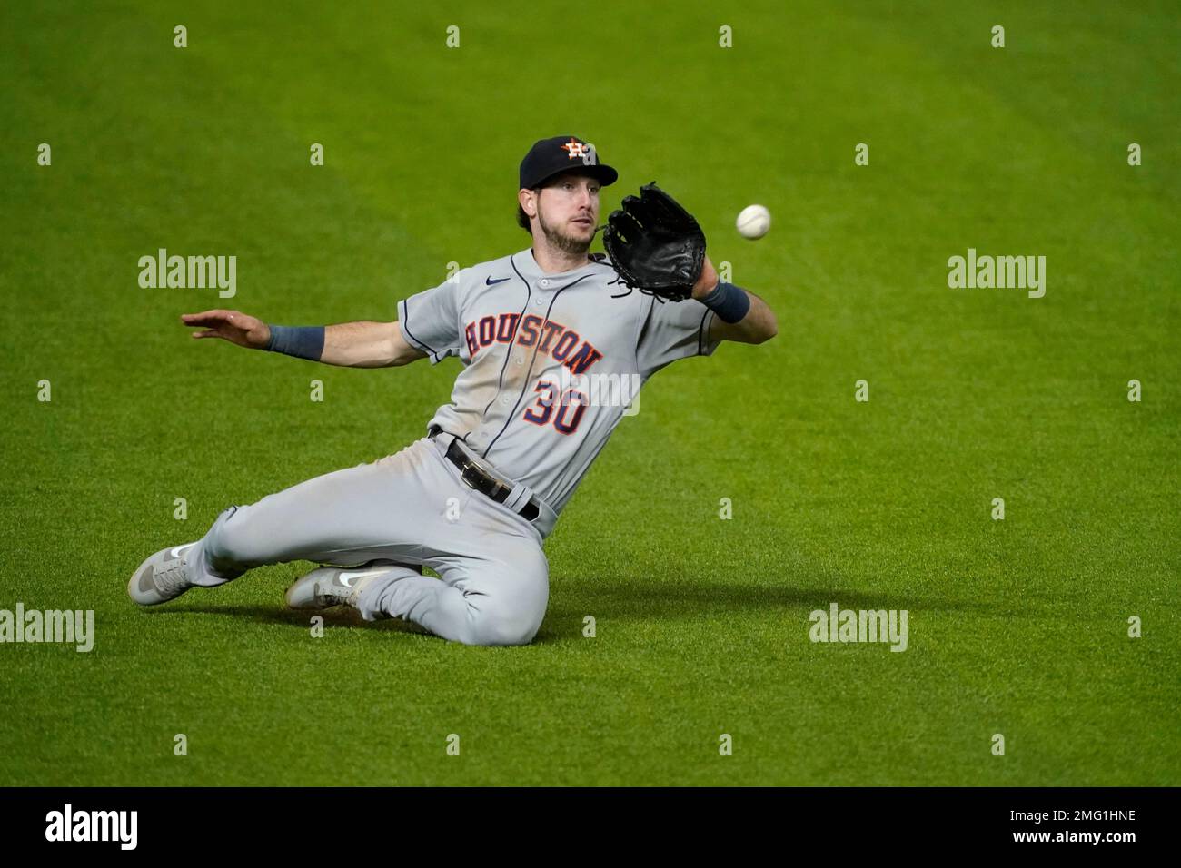 Houston Astros left fielder Kyle Tucker leans out to catch a Texas