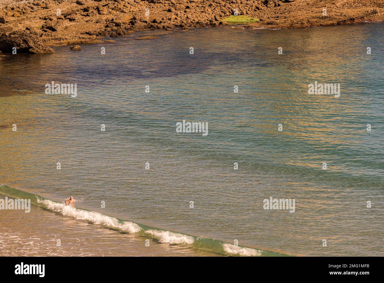 aerial view of a man bathing on the seashore at Langre beach, Cantabria, Spain, Europe Stock Photo