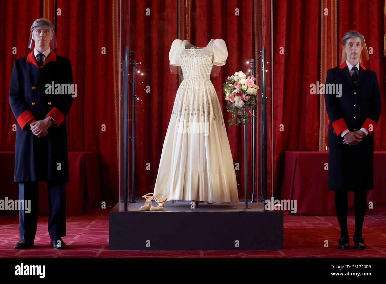 Two wardens stand by Princess Beatrice's wedding dress, designed by the