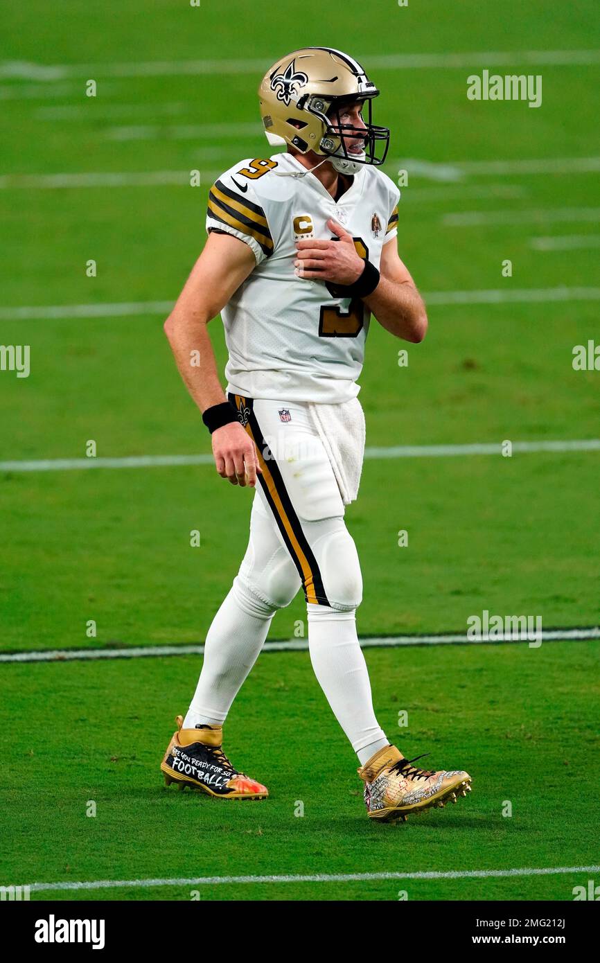 A detail shot of New Orleans Saints quarterback Drew Brees #9 cleats as he  walks on the field between plays against the Las Vegas Raiders during an  NFL football game, Monday, Sept.