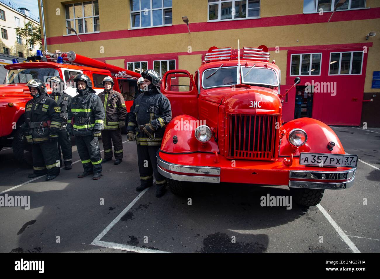 Firefighters gather next to a Soviet era fire truck ZIS, a plant ...
