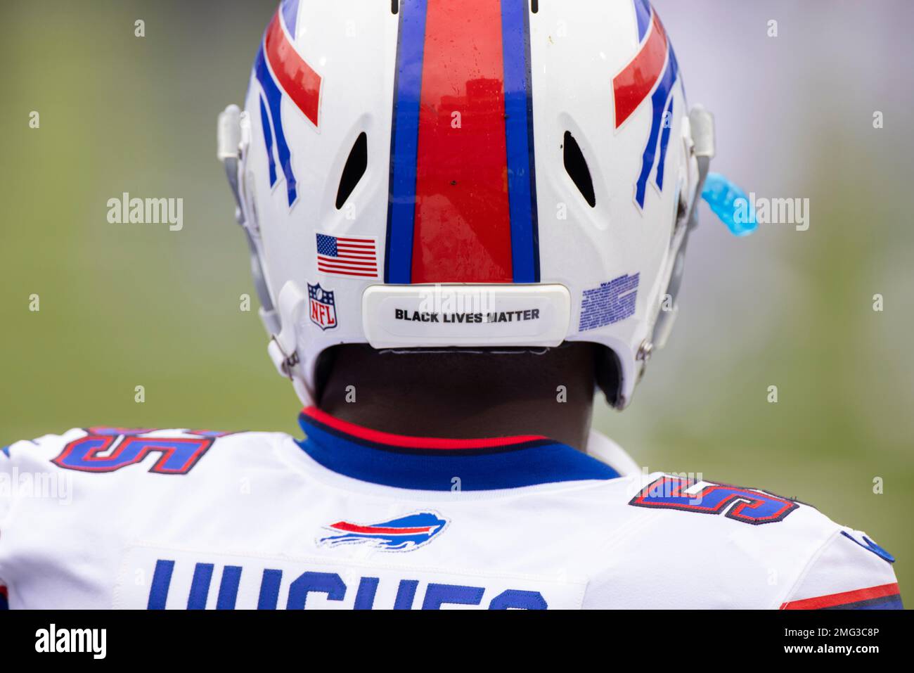 Buffalo Bills' Jerry Hughes gets his helmet stuck on teammate's jersey