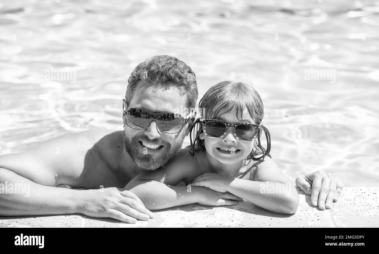happy family of daddy and little boy having fun in summer swimming pool, family Stock Photo