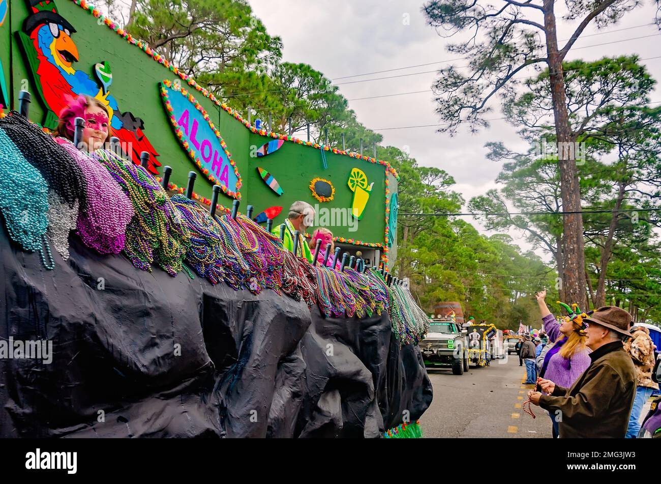 Members of Krewe de la Dauphine ride a Mardi Gras float during the