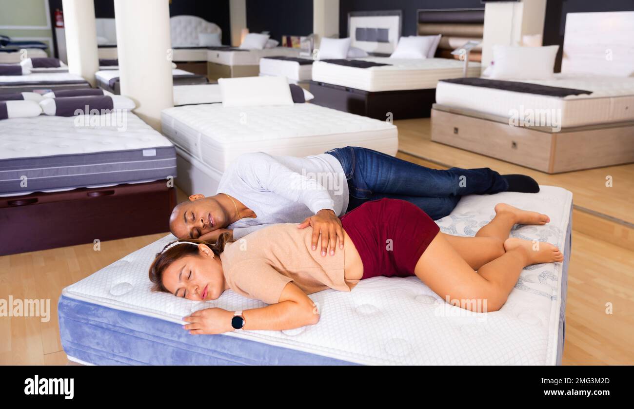Husband and wife fell asleep on new mattress in a furniture store Stock Photo Alamy