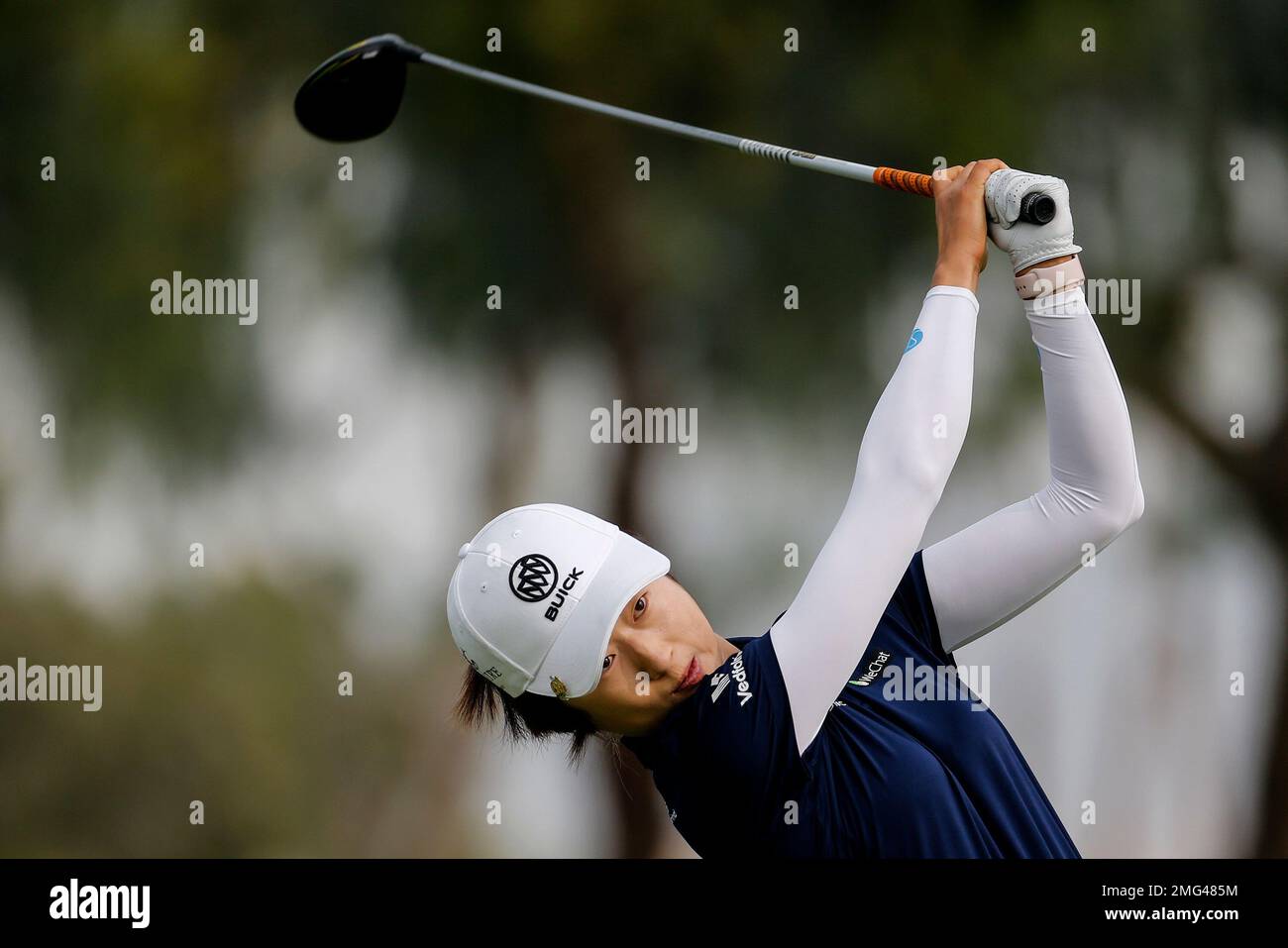 Yu Liu, of China, follows through on a shot on the second hole during