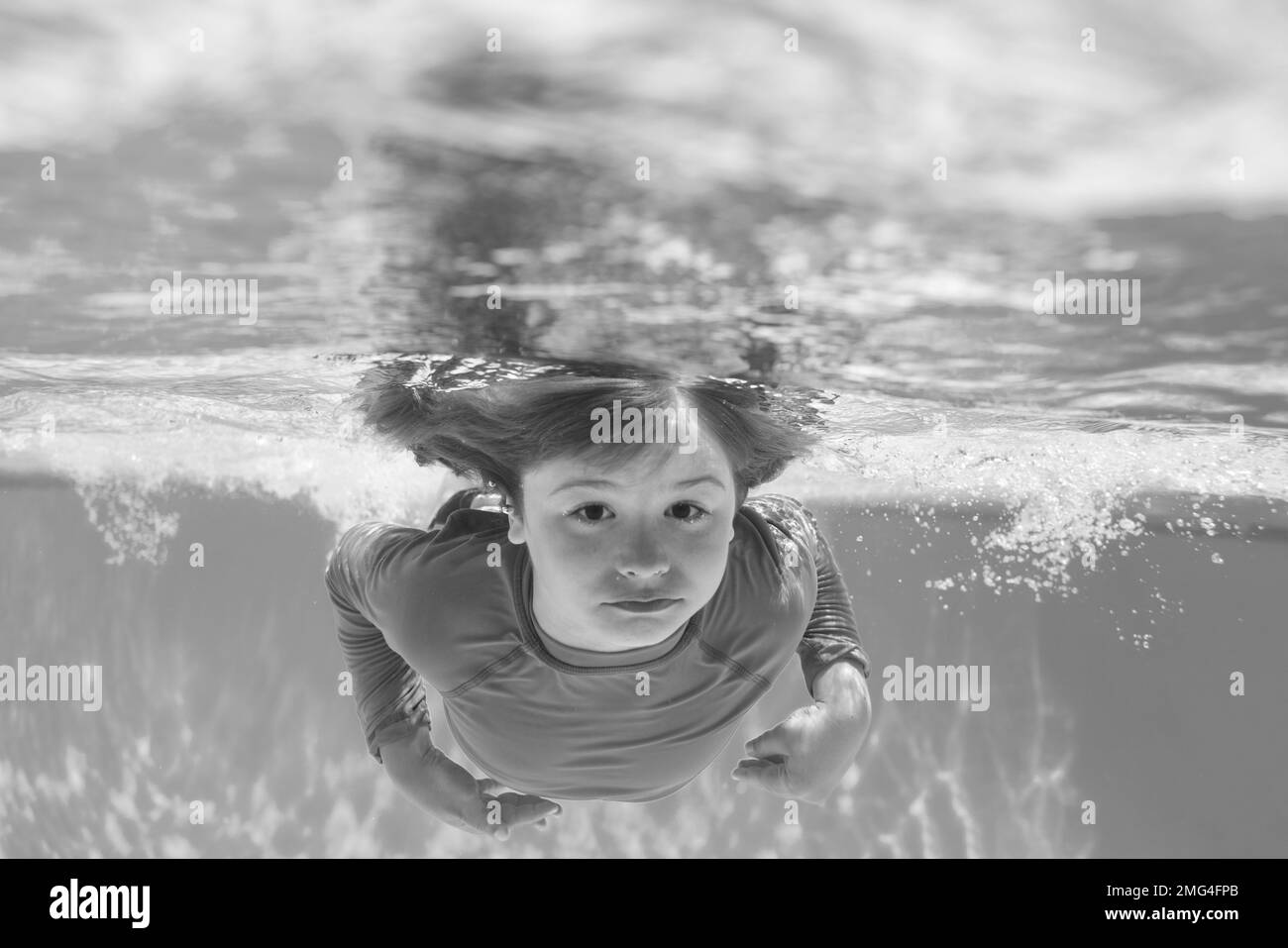 Kid boy swim underwater in sea. Kid swimming in pool under water