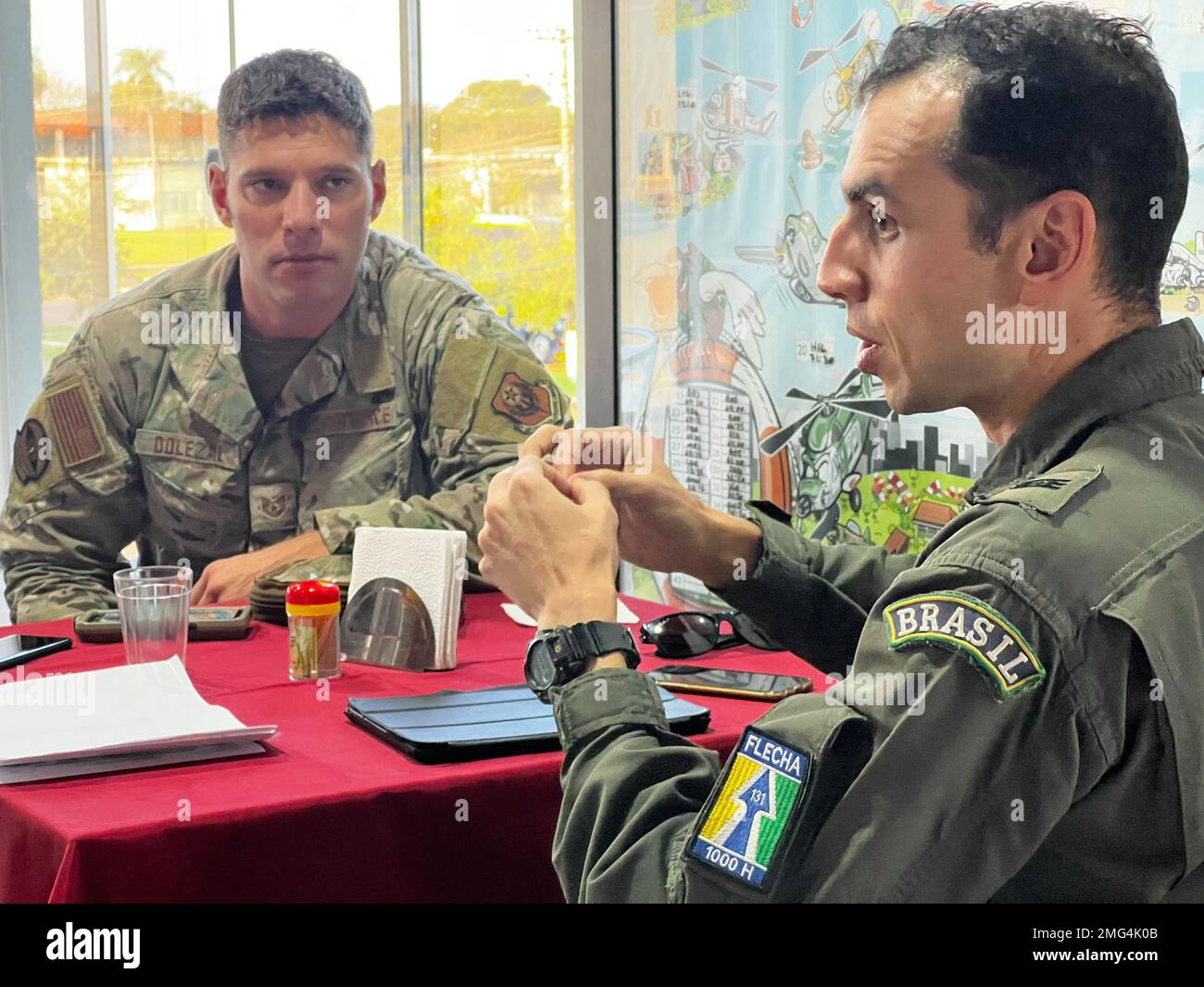Capt. Diego Marques, an A-29 Super Tucano pilot with the Brazilian Air  Force discusses plans with TAir Force Tech. Sgt. Jeff Dolzel a member of  the 121 Special Tactics Squadron of the