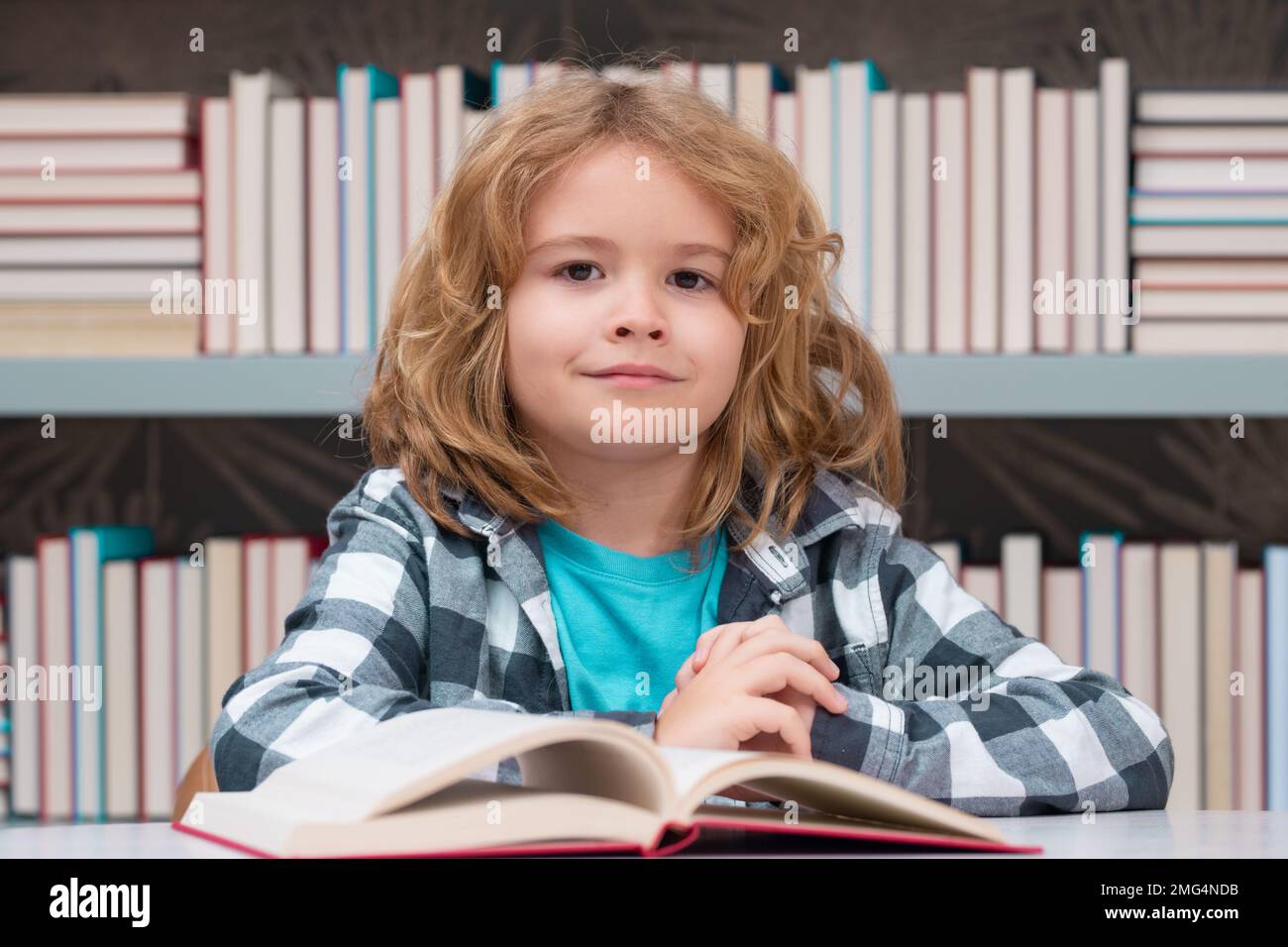 Child reading book in a book store or library, Stock Photo