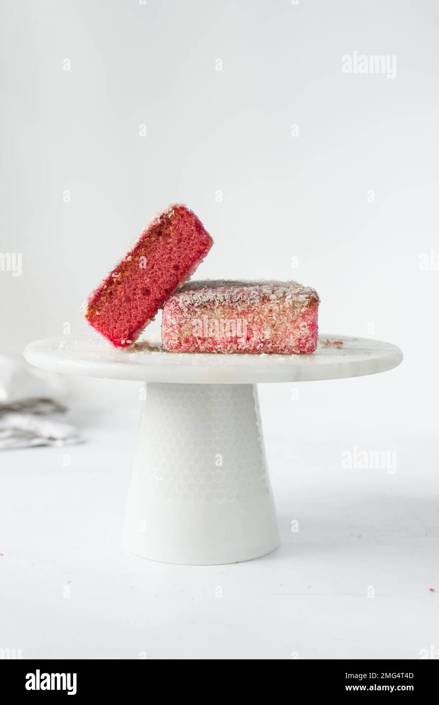 strawberry cakes on a marble cake stand, pink strawberry cake slices on