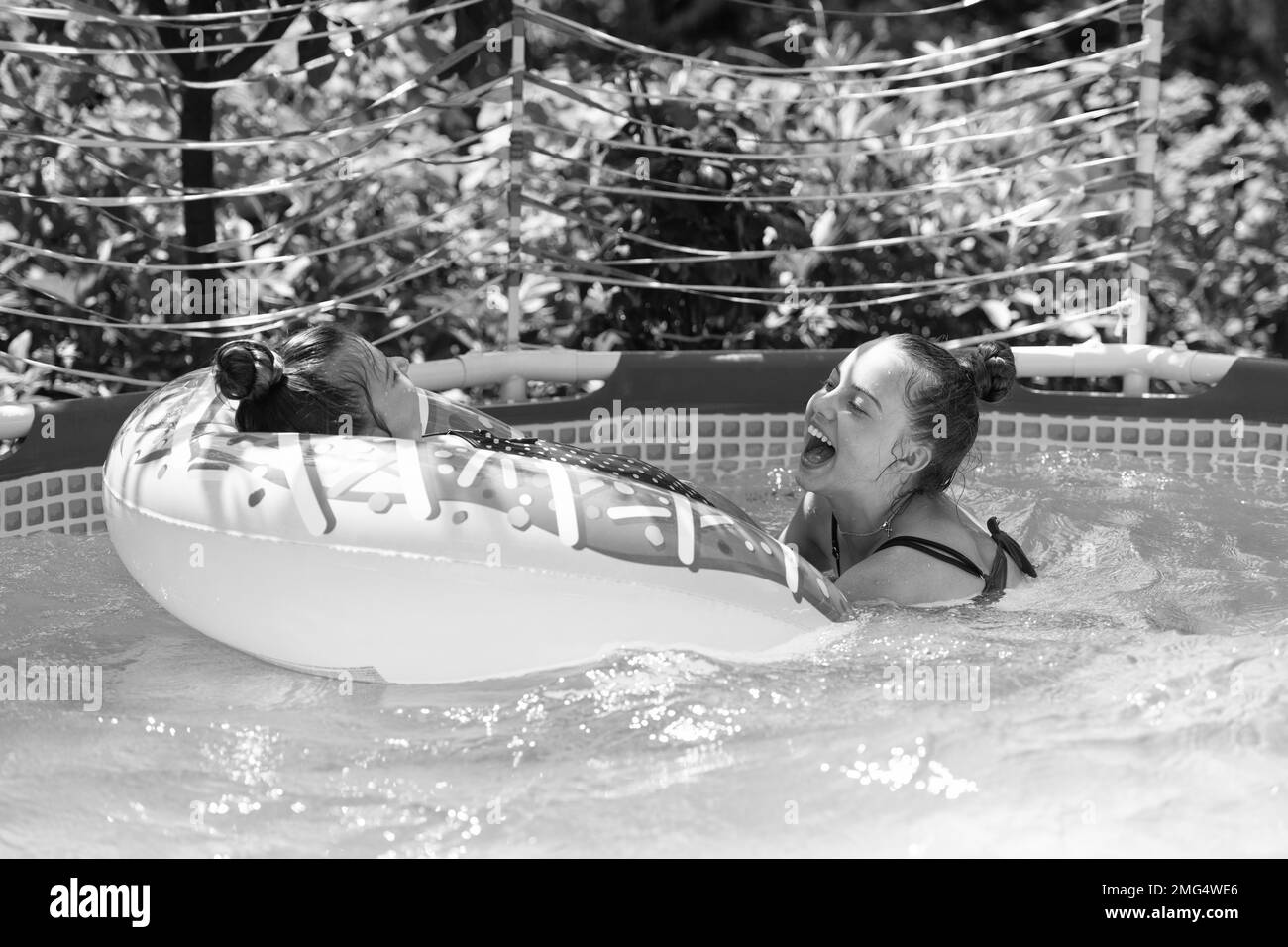 Summer fun. Children swim in pool. Fun swimming pool games. Summer