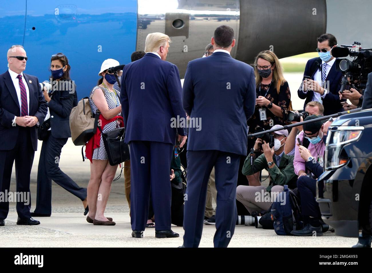 President Donald Trump talks to reporters before boarding Air Force One ...