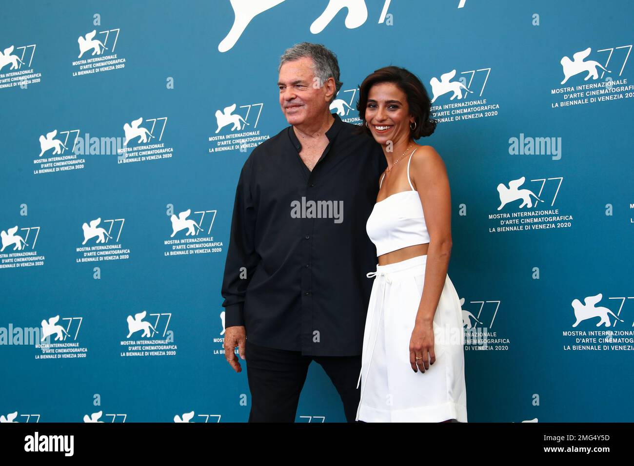 Director Amos Gitai, left, and actress Bahira Ablassi pose for photographers at the photo call for the film 'Laila in Haifa' during the 77th edition of the Venice Film Festival in Venice, Italy, Tuesday, Sept. 8, 2020. (Photo by Joel C Ryan/Invision/AP) Stock Photo