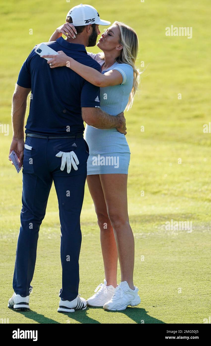 Dustin Johnson celebrates with his partner Paulina Gretzky on the 18th