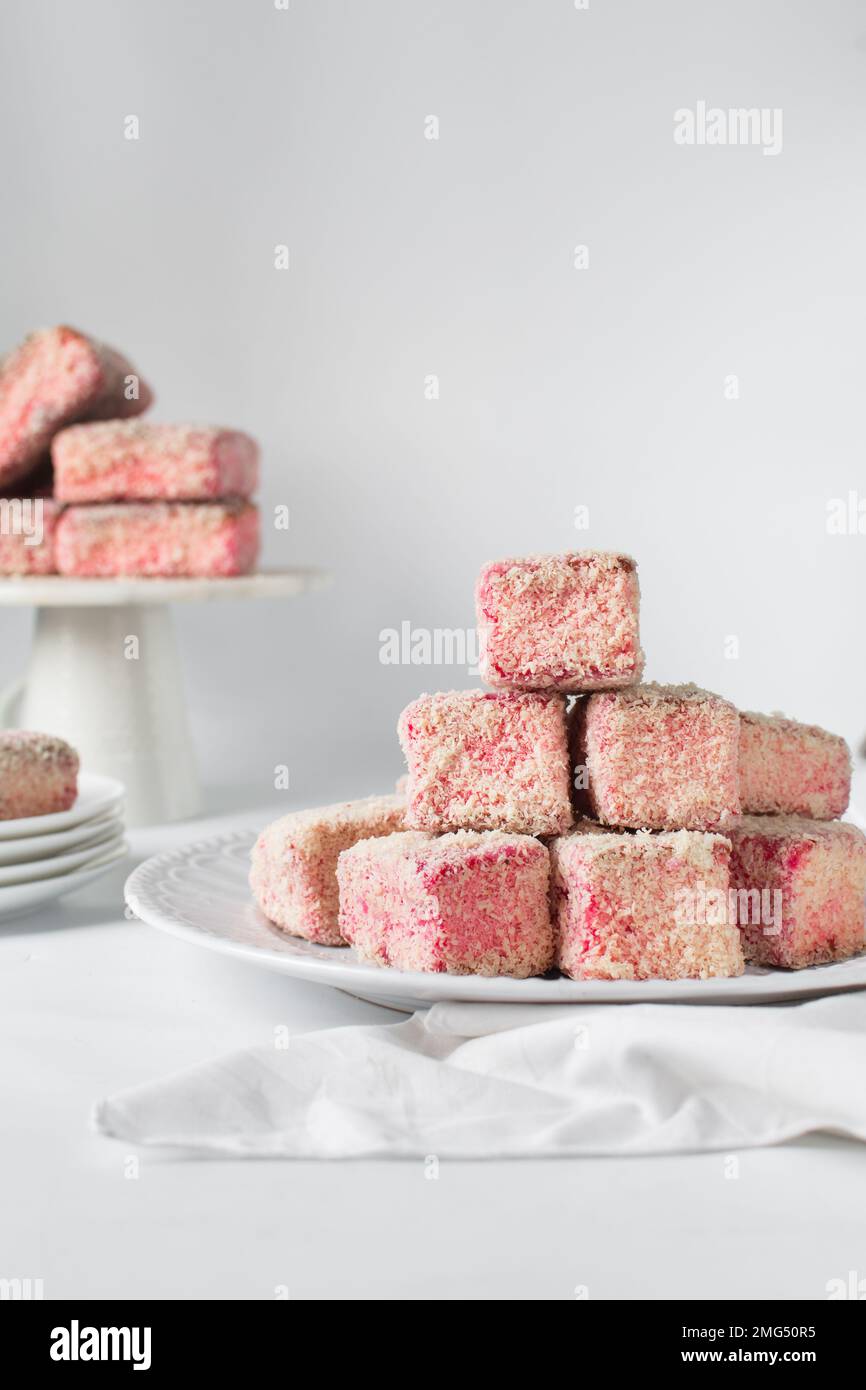 Pink lamingtons on a marble tray, Australian raspberry lamingtons, cake