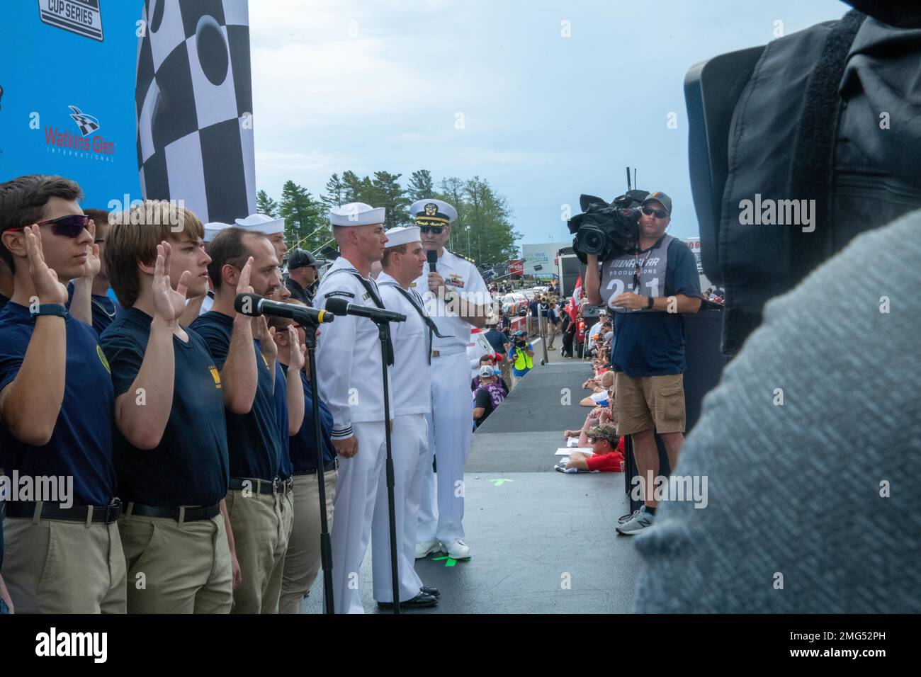 220821-N-UK583-0058 WATKINS GLEN, N.Y. (August 21, 2022) — Future Sailors and recruiters from Navy Talent Acquisition Group (NTAG) Pittsburgh pose for a photo at the Go Bowling at The Glen, NASCAR Xfinity Series race prior to a mass enlistment ceremony. More than 11 future Sailors took the oath of enlistment at the event. Cmdr. Christopher McCurry, commanding officer of NTAG Pittsburgh administered the oath. NTAG Pittsburgh, part of Navy Recruiting Command, recruits the next generation of Navy Sailors throughout areas in Pennsylvania, New York, West Virginia, and Maryland. Stock Photo