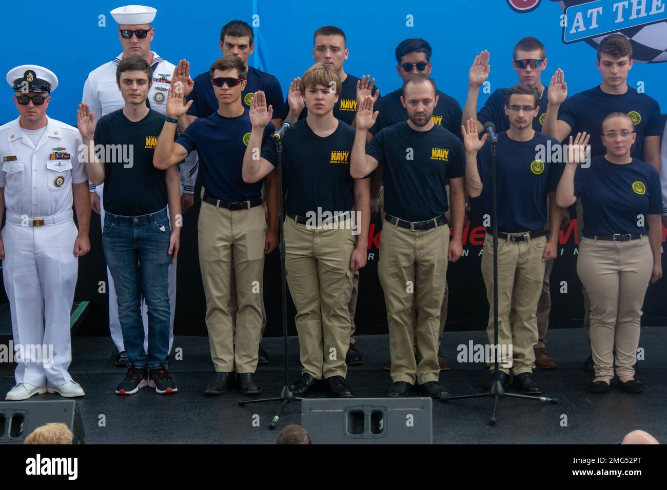 220821-N-RB168-0328 WATKINS GLEN, N.Y. (August 21, 2022) —  Eleven Future Sailors from Navy Talent Acquisition Group (NTAG) Pittsburgh take the oath of enlistment at the Go Bowling at the Watkins Glen NASCAR Xfinity Series race. Cmdr. Christopher McCurry, from Aloha, Ore., administered the oath. NTAG Pittsburgh, part of Navy Recruiting Command, recruits the next generation of Navy Sailors throughout areas in Pennsylvania, New York, West Virginia, and Maryland. Stock Photo