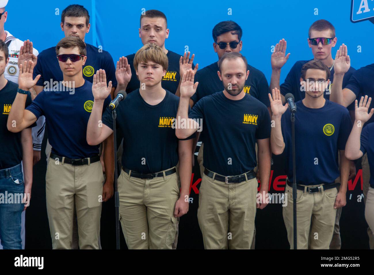 220821-N-RB168-0311 WATKINS GLEN, N.Y. (August 21, 2022) —  Eleven Future Sailors from Navy Talent Acquisition Group (NTAG) Pittsburgh take the oath of enlistment at the Go Bowling at the Watkins Glen NASCAR Xfinity Series race. Cmdr. Christopher McCurry, from Aloha, Ore., administered the oath. NTAG Pittsburgh, part of Navy Recruiting Command, recruits the next generation of Navy Sailors throughout areas in Pennsylvania, New York, West Virginia, and Maryland. Stock Photo
