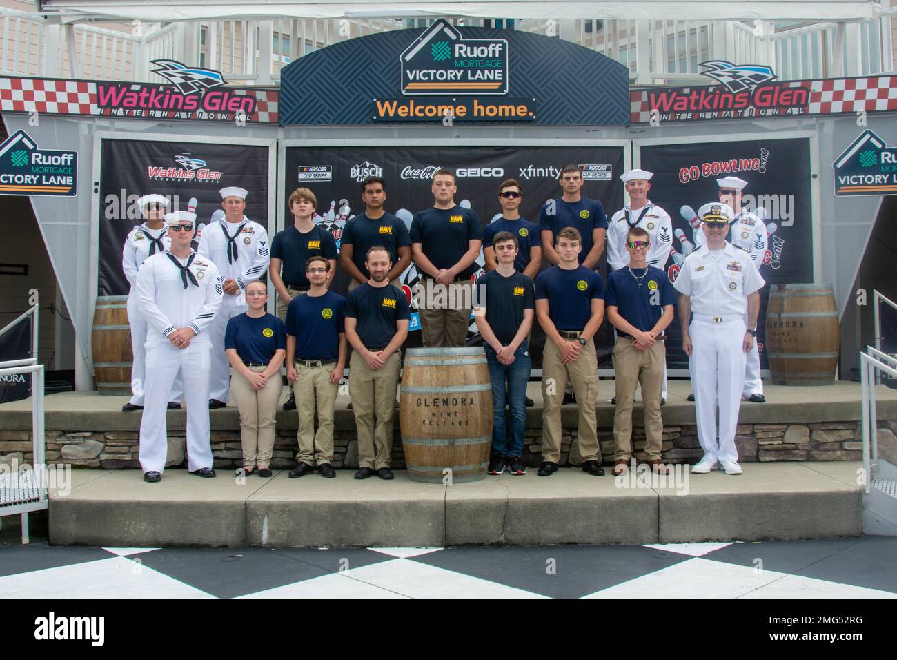 220821-N-RB168-0366 WATKINS GLEN, N.Y. (August 21, 2022) —  Future Sailors and recruiters from Navy Talent Acquisition Group (NTAG) Pittsburgh pose for a photo at the Go Bowling at The Glen, NASCAR Xfinity Series race following a mass enlistment ceremony. Cmdr. Christopher McCurry, commanding officer of NTAG Pittsburgh administered the oath for more than 11 future Sailors at the event. NTAG Pittsburgh, part of Navy Recruiting Command, recruits the next generation of Navy Sailors throughout areas in Pennsylvania, New York, West Virginia, and Maryland. Stock Photo