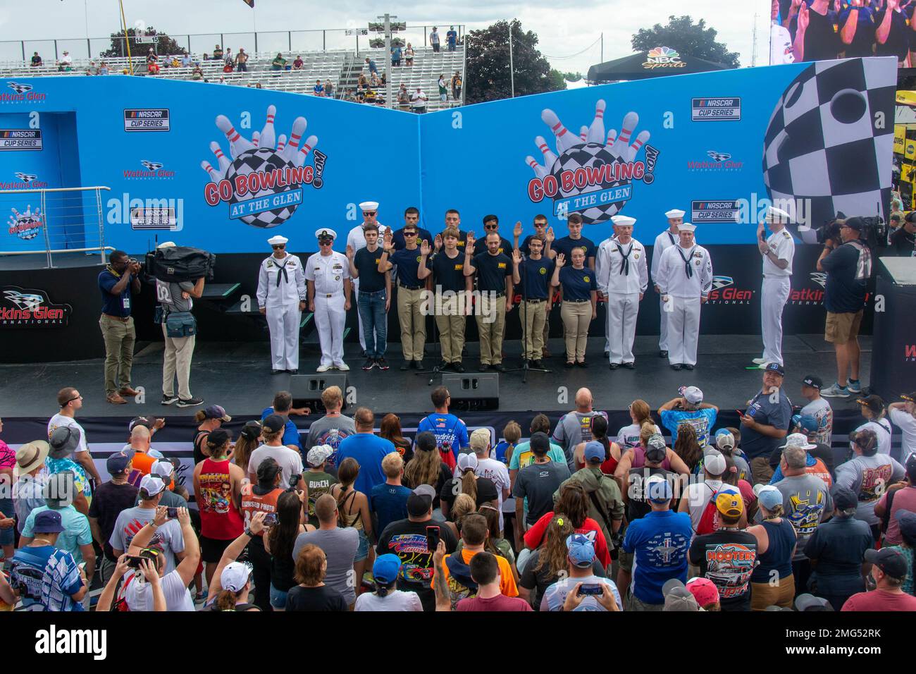 220821-N-RB168-0314 WATKINS GLEN, N.Y. (August 21, 2022) —  Eleven Future Sailors from Navy Talent Acquisition Group (NTAG) Pittsburgh take the oath of enlistment at the Go Bowling at the Watkins Glen NASCAR Xfinity Series race. Cmdr. Christopher McCurry, from Aloha, Ore., administered the oath. NTAG Pittsburgh, part of Navy Recruiting Command, recruits the next generation of Navy Sailors throughout areas in Pennsylvania, New York, West Virginia, and Maryland. Stock Photo