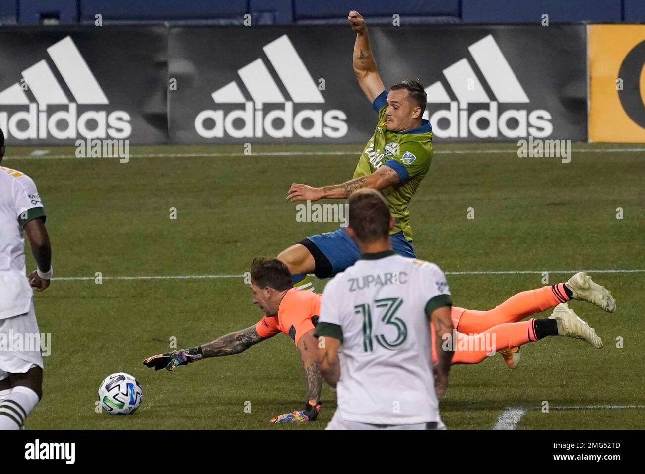 Seattle Sounders forward Jordan Morris, center, tangles with Portland