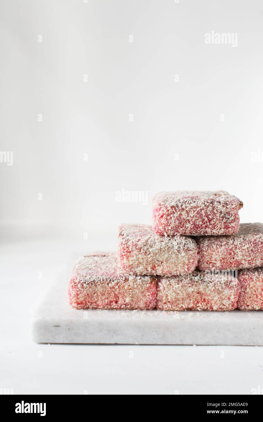 Pink lamingtons on a marble tray, Australian raspberry lamingtons, cake