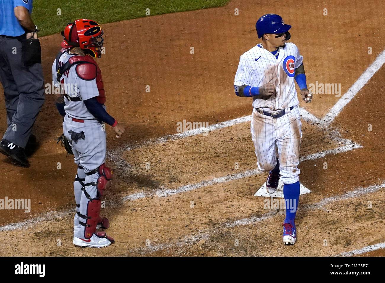 Chicago Cubs' Javier Baez, right, scores on a one-run single by