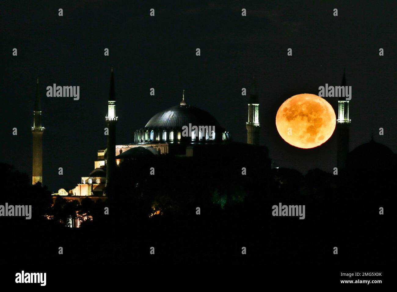The full moon rises behind the Byzantine-era Hagia Sophia in the ...