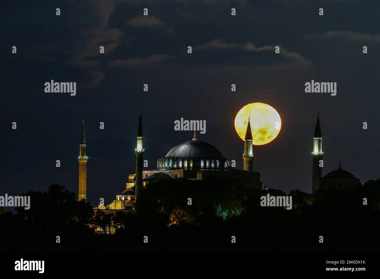 The full moon rises behind the Byzantine-era Hagia Sophia in the ...