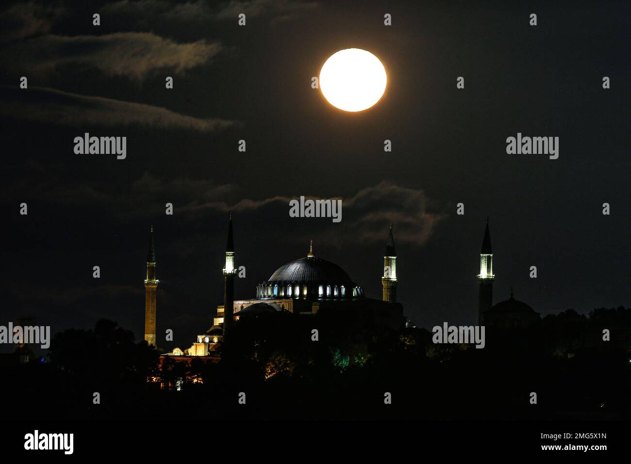 The full moon rises behind the Byzantine-era Hagia Sophia, in the ...