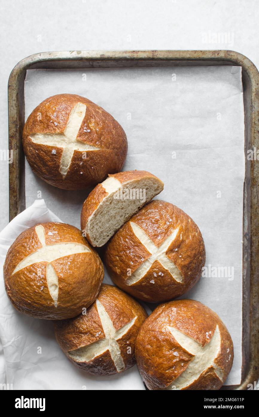 Top view of Pretzel buns on a parchment lined baking sheet, German