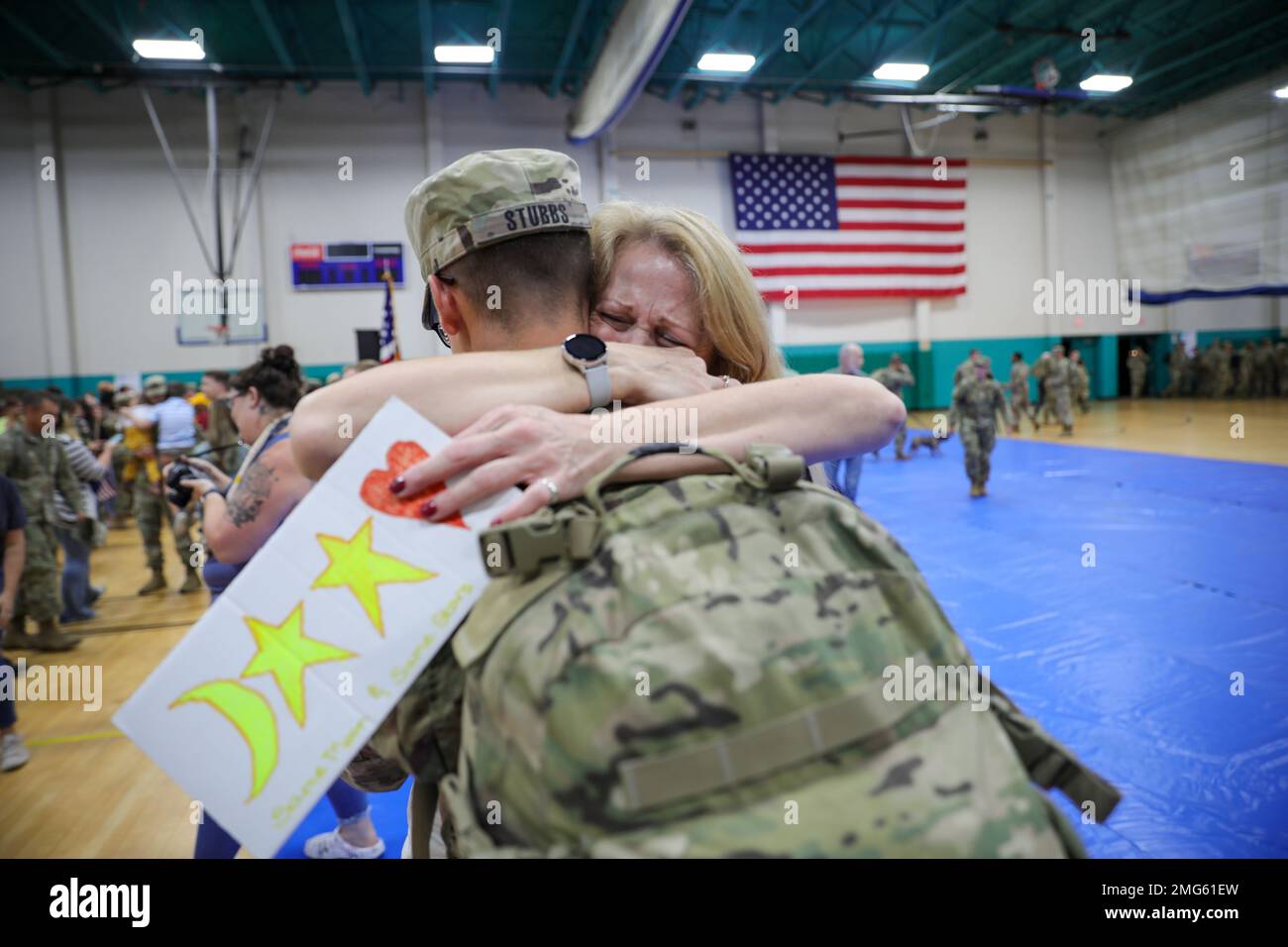 U.S. Army Cpl. John Stubbs, a human intelligence collector assigned to the 10th Brigade Engineer Battalion, 1st Armored Brigade Combat Team, 3rd Infantry Division, and his mother, Laurel Stubbs, share a tearful embrace during a welcome home ceremony at Fort Stewart, Georgia, Aug. 22, 2022. The “Raider” Brigade is constantly deployment-ready to protect the core principles found in the United States Constitution against all enemies who may jeopardize those values, both foreign and domestic. Stock Photo
