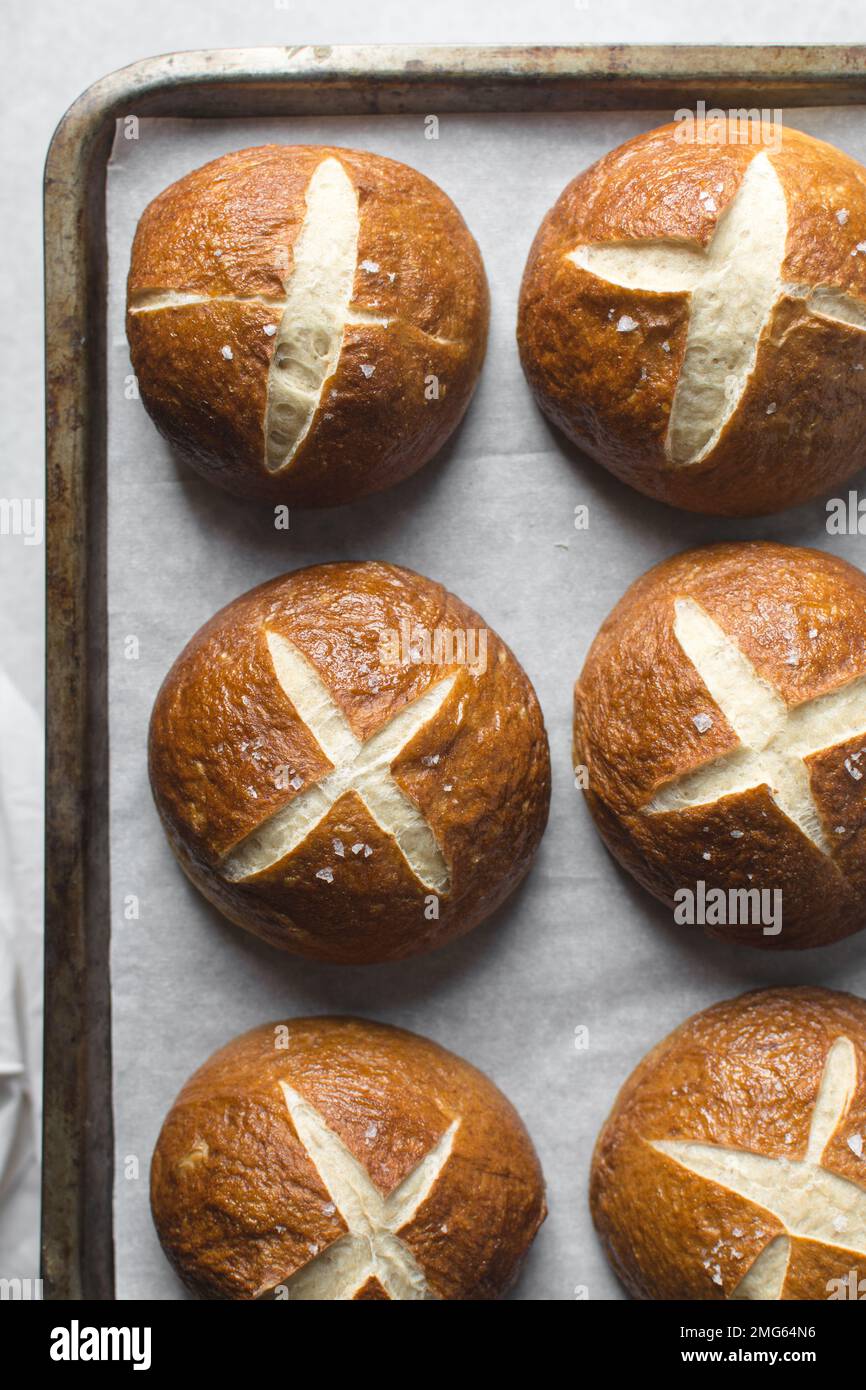 Top view of Pretzel buns on a parchment lined baking sheet, German