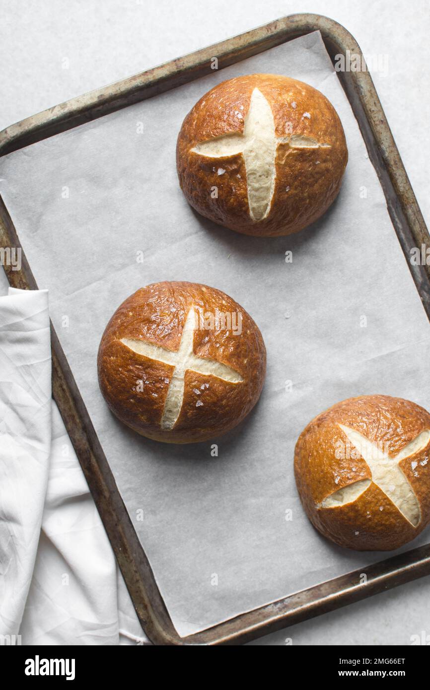 Top view of Pretzel buns on a parchment lined baking sheet, German