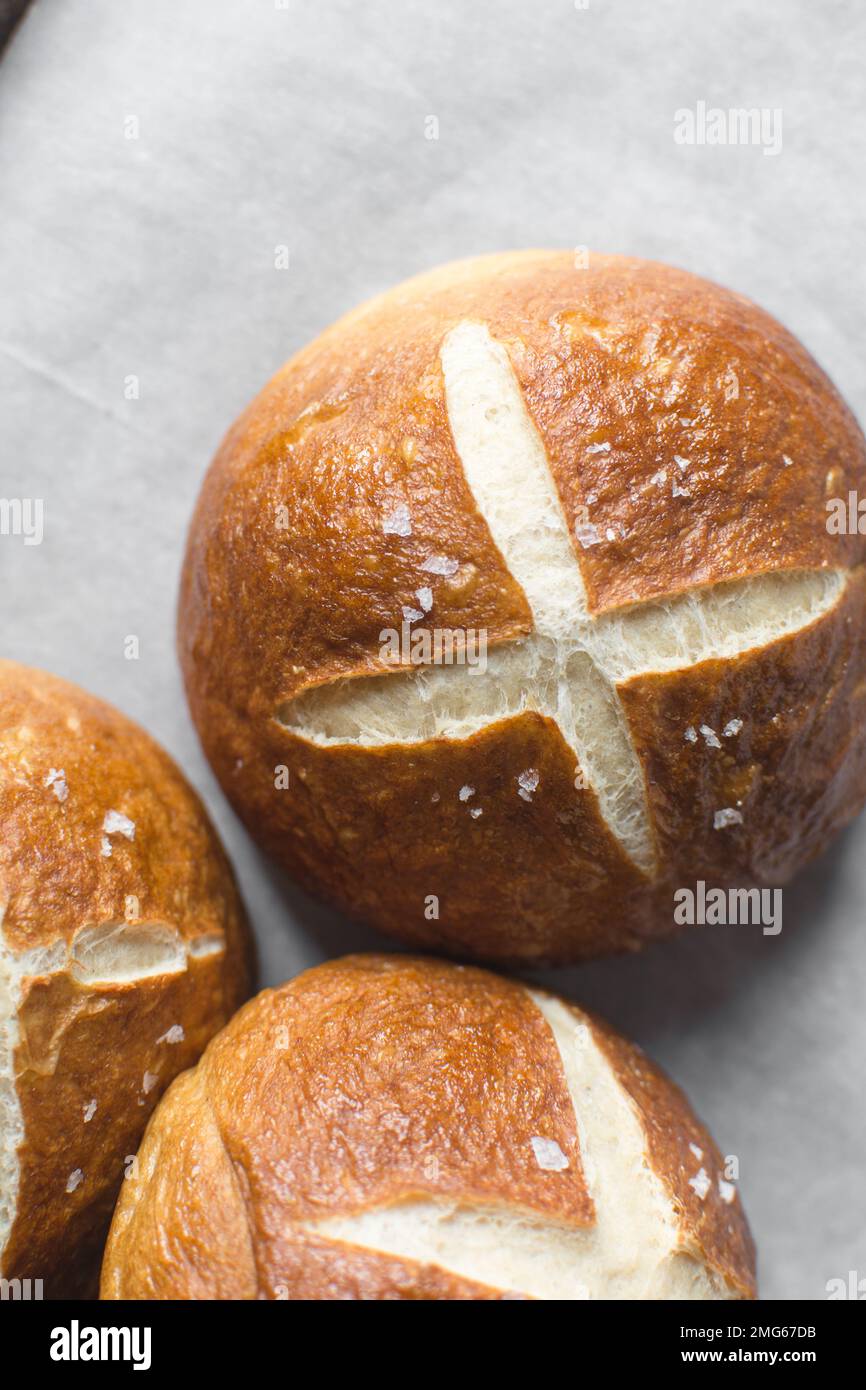 Top view of Pretzel buns on a parchment lined baking sheet, German