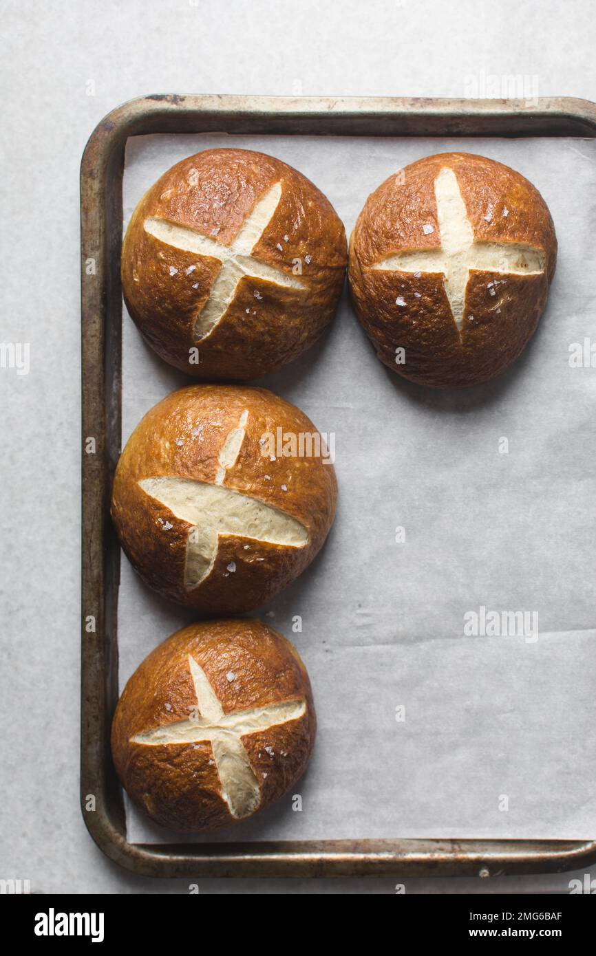 Top view of Pretzel buns on a parchment lined baking sheet, German