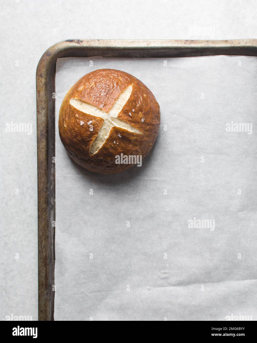 Top view of Pretzel buns on a parchment lined baking sheet, German