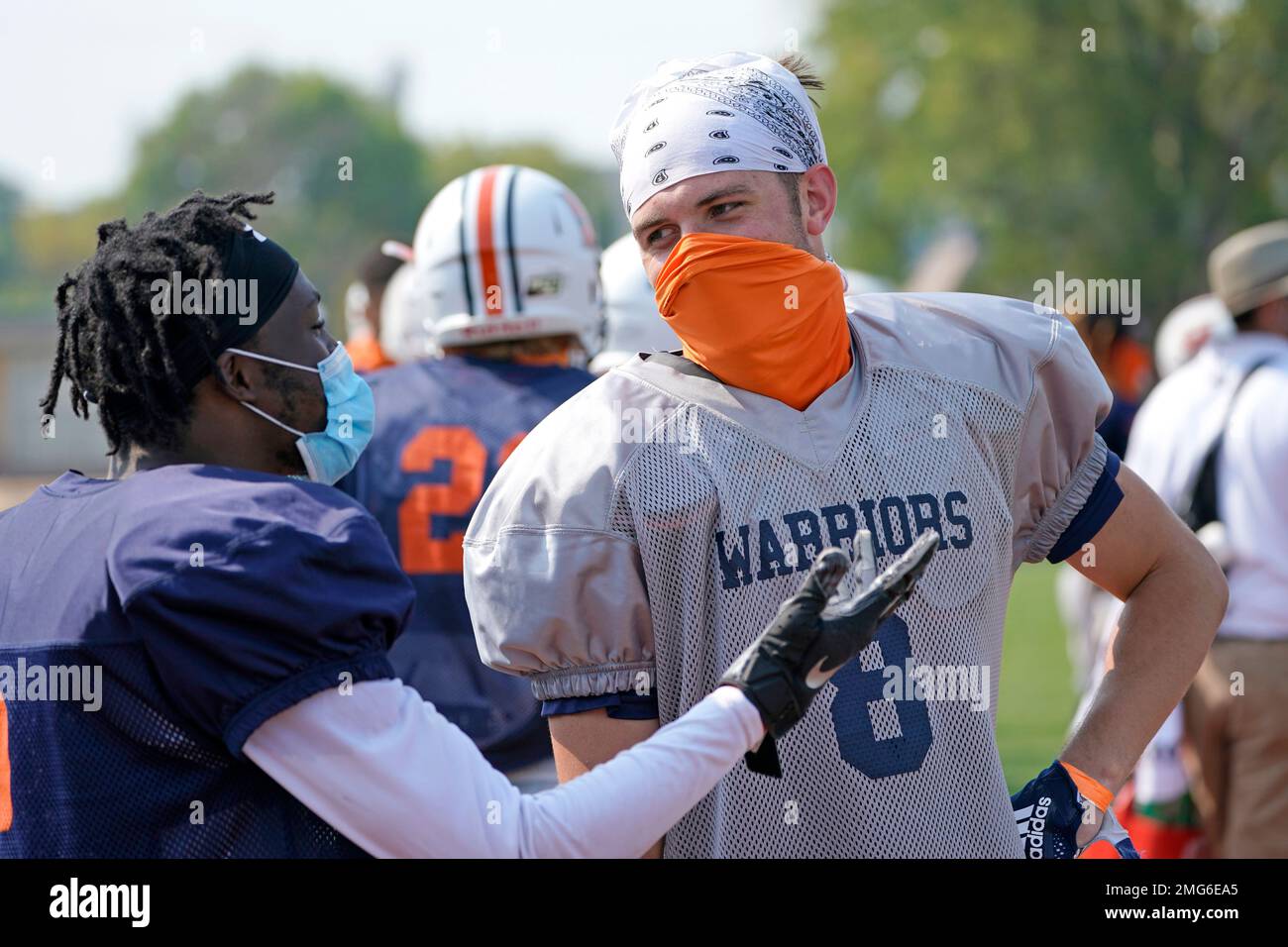 Midland University tight end Austin Harris right chats with a