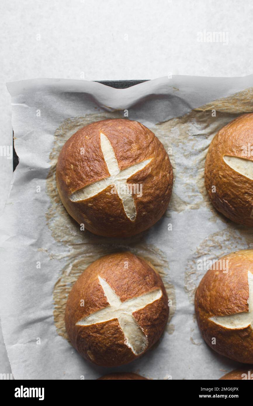 Top view of Pretzel buns on a parchment lined baking sheet, German